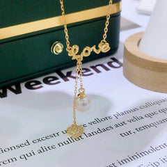 The Pearl of My Heart necklace displayed on green jewelry box with pearl drop and gold heart charm