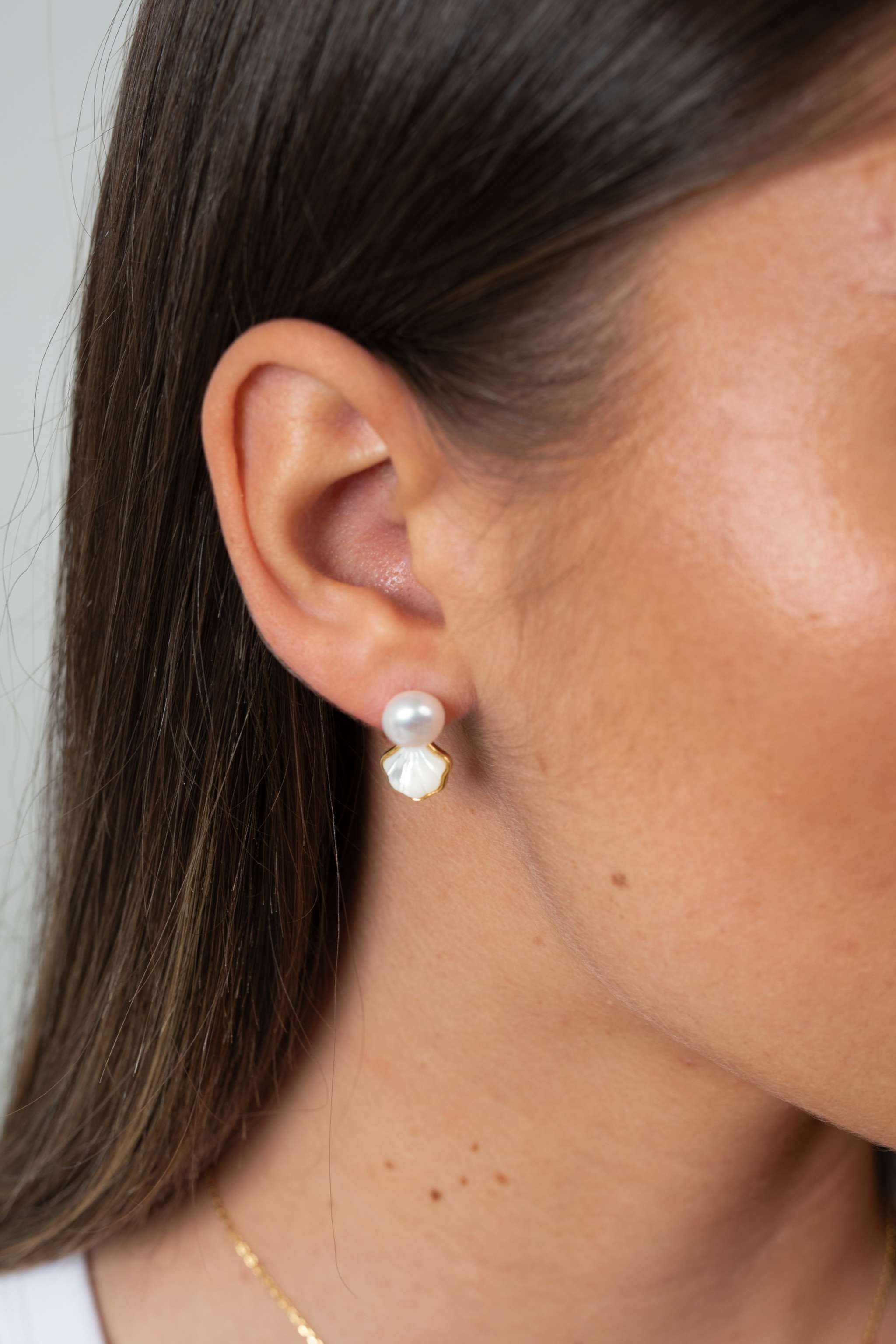 Side profile of woman wearing Shellora sterling silver pearl earrings
