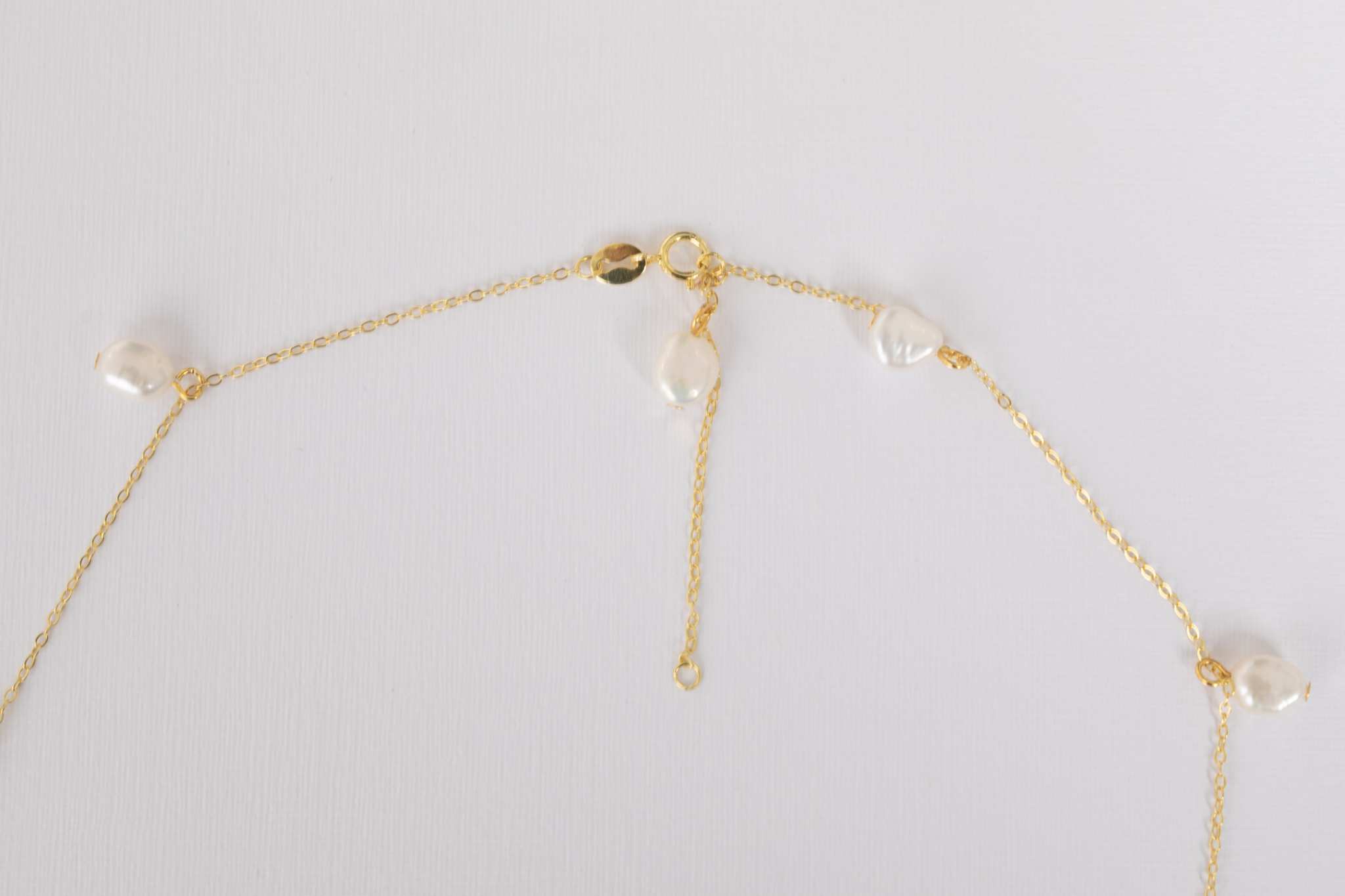 Detailed shot of Elisette Pearl Choker pearls and 18K gold plated sterling silver accents
