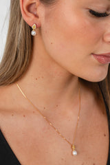 Woman wearing Citrine Glow earrings with freshwater pearls and yellow zircon stones