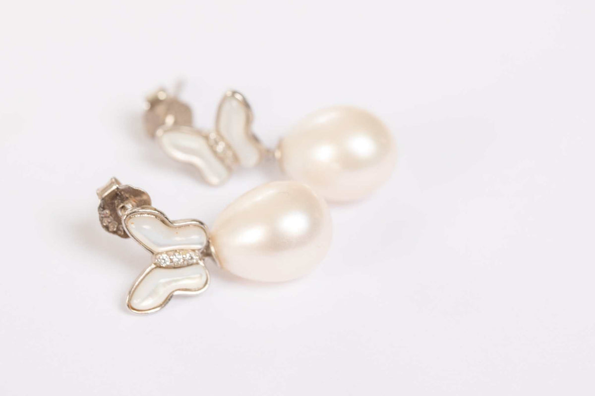 Butterfly Pearl Whisper earrings featuring gold butterfly design with freshwater pearl drops