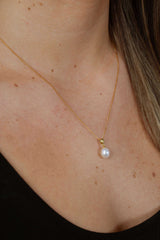 Woman wearing Droplet Chic freshwater pearl necklace with minimalist gold plated design