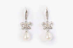 Lily Serenade earrings featuring freshwater pearl drops and sterling silver bow motif