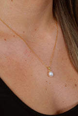 Droplet Chic necklace on model showcasing simple pearl drop and elegant gold chain