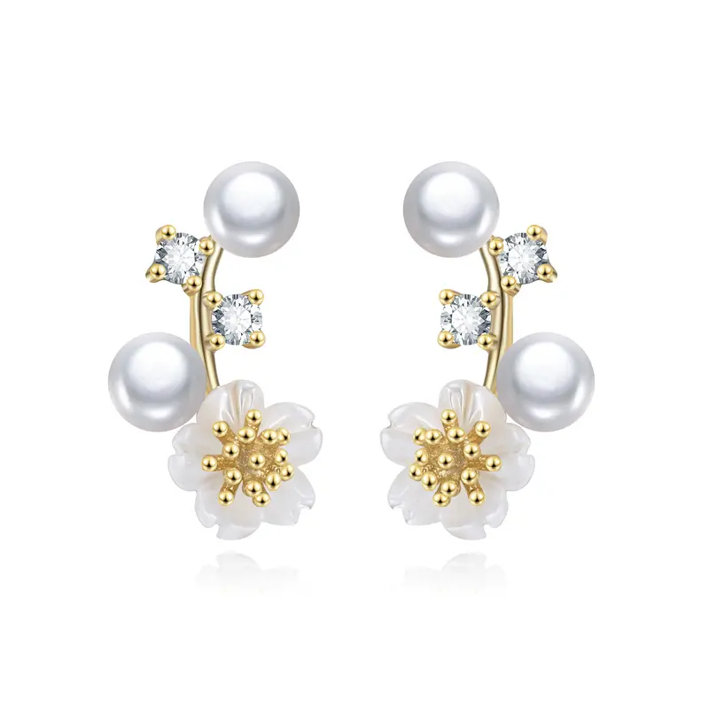 Close-up of Pearl Blossom stud earrings featuring gold floral accents and freshwater pearls