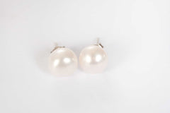 queens glow pearl stud earrings on white background