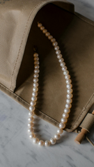 Elegant 3–4 mm freshwater pearl necklace from Pearlisma styled with black off-shoulder dress