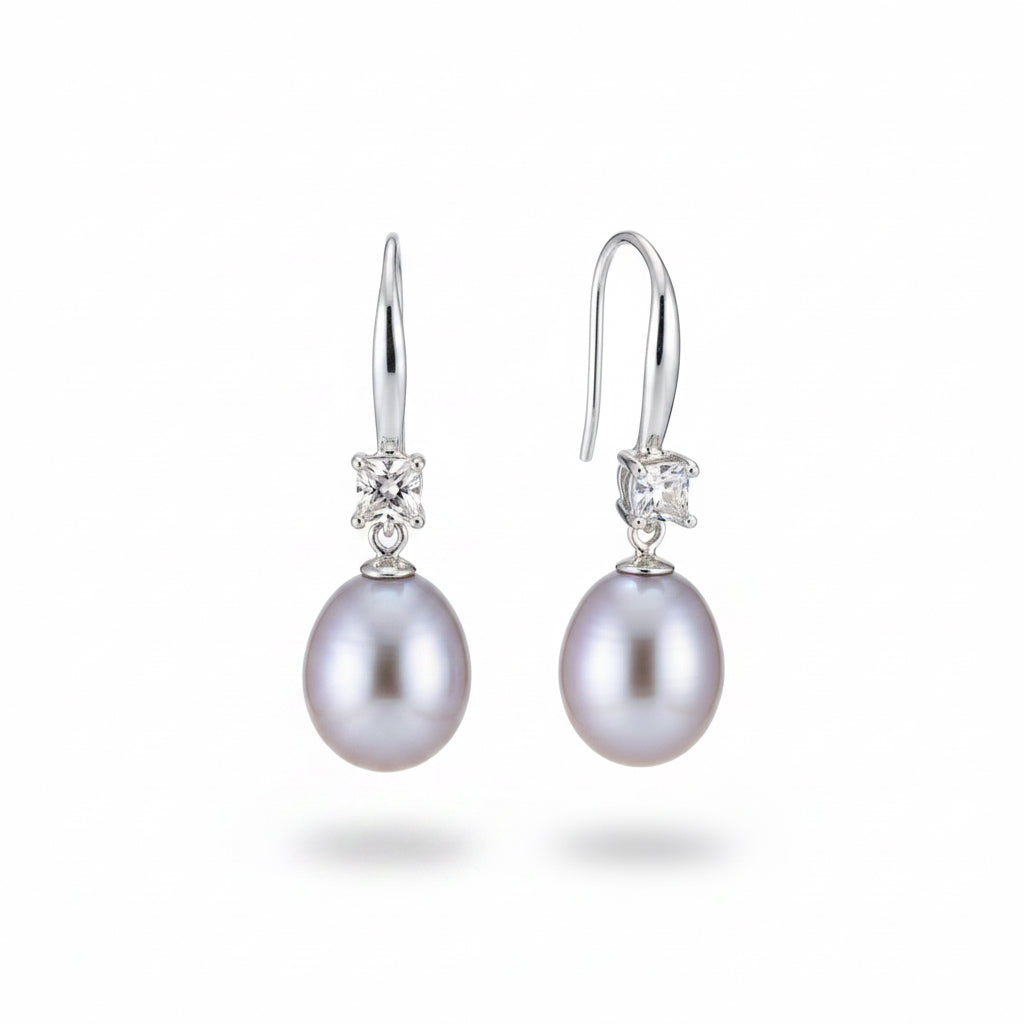 close up of silver cascade pearl earrings with zircon stones