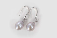 close up of silver cascade pearl earrings with zircon stones