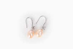 stylish pearl cascade earrings photographed in minimal studio lighting