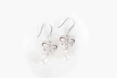 elegant silver lily flower pearl drop earrings on white background