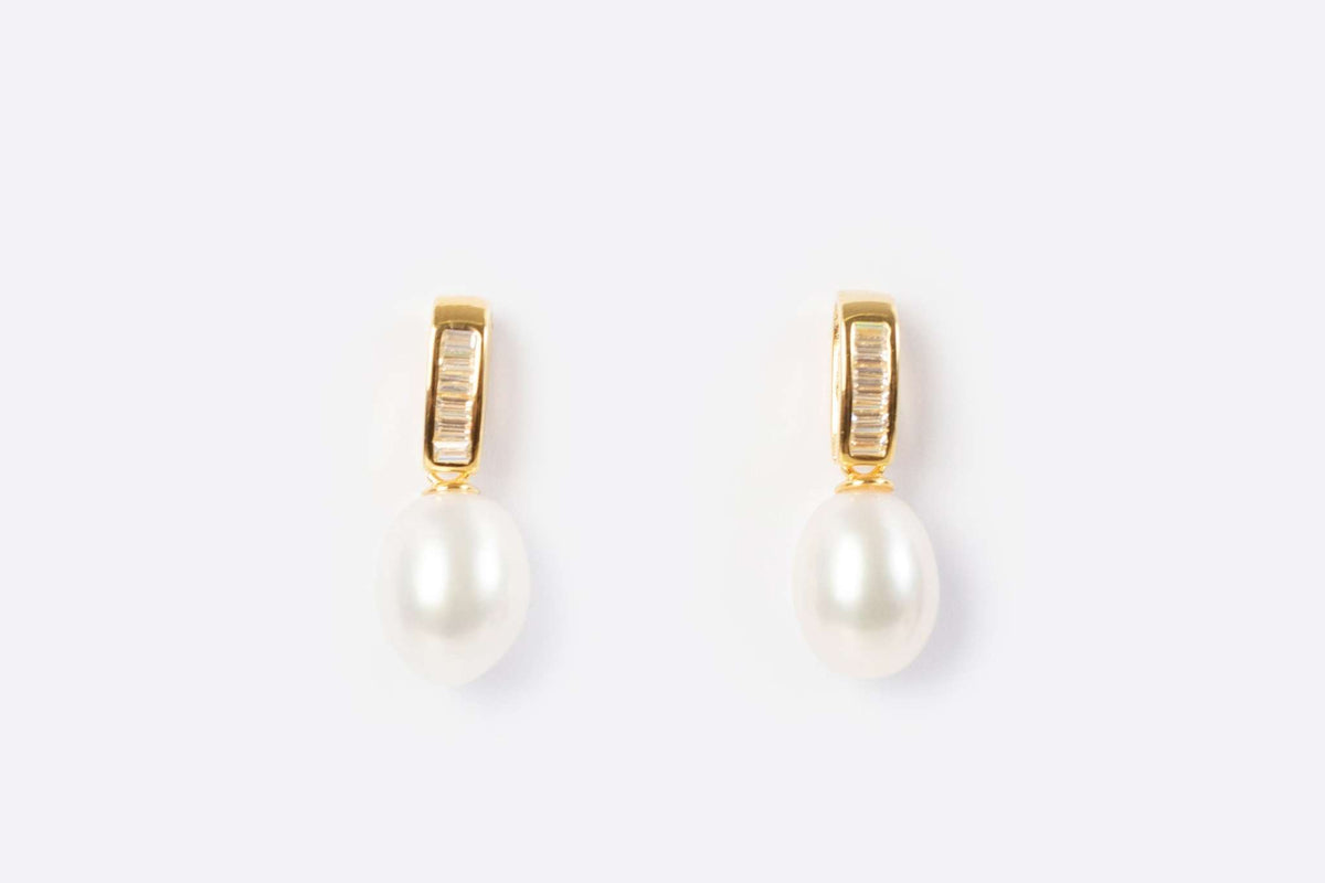 gold pearl drop earrings with freshwater pearls on white background