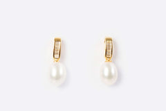 gold pearl drop earrings with freshwater pearls on white background