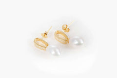 close up of gold cascade earrings with delicate freshwater pearls