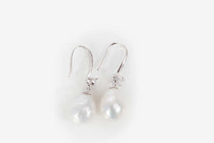 Delicate pearl drop earrings featuring soft pink 10mm freshwater pearls