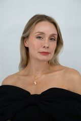 Close-up of Fleur de Perle necklace featuring pearl drop and yellow zircon stones on 18K gold plated sterling silver