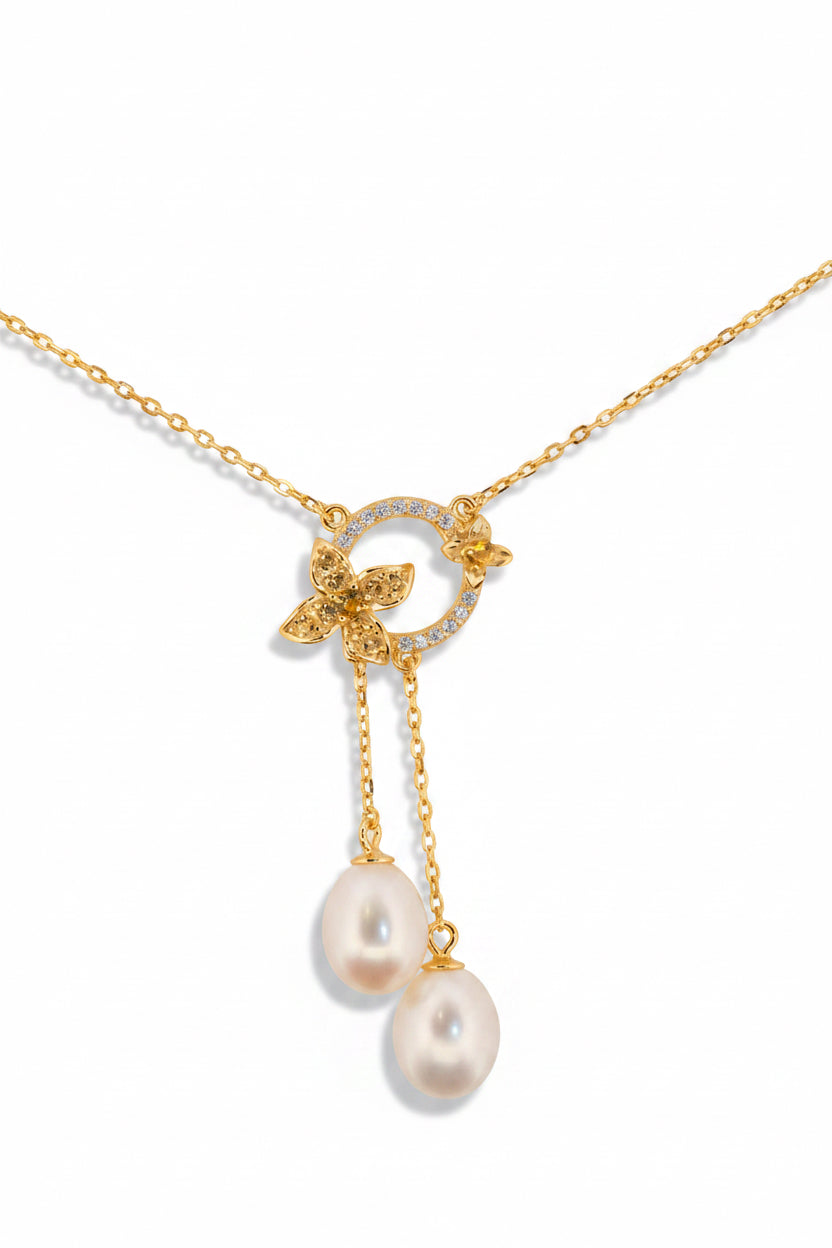 Close-up of Fleur de Perle necklace featuring pearl drop and yellow zircon stones on 18K gold plated sterling silver