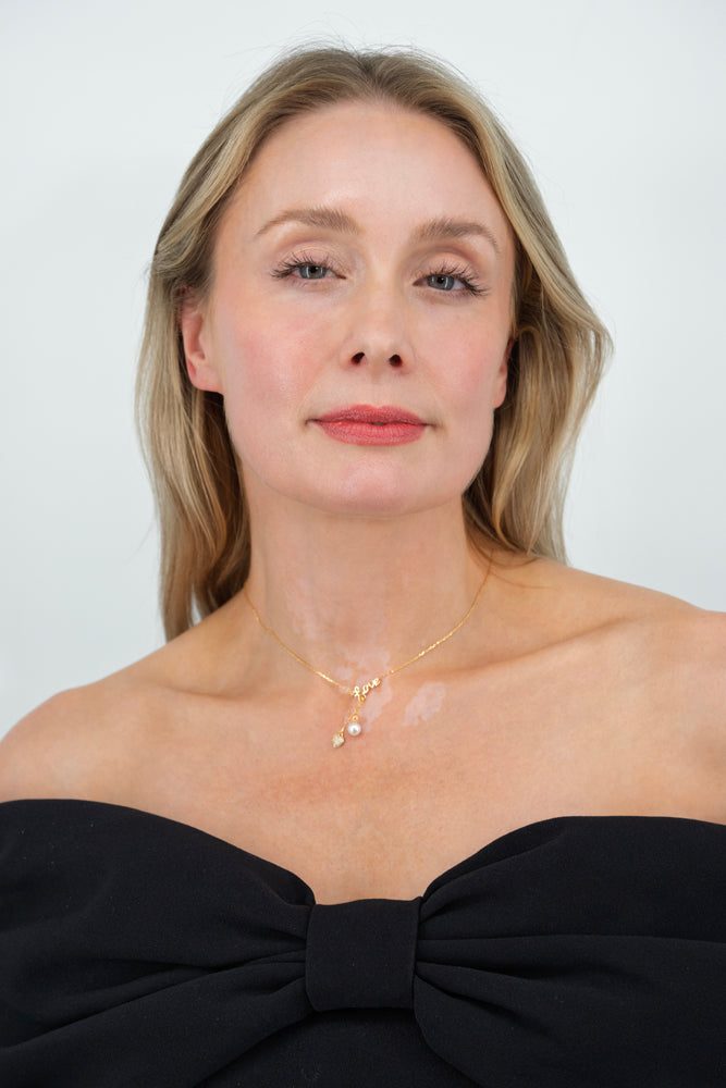 Woman wearing The Pearl of My Heart necklace featuring freshwater pearl and heart pendant