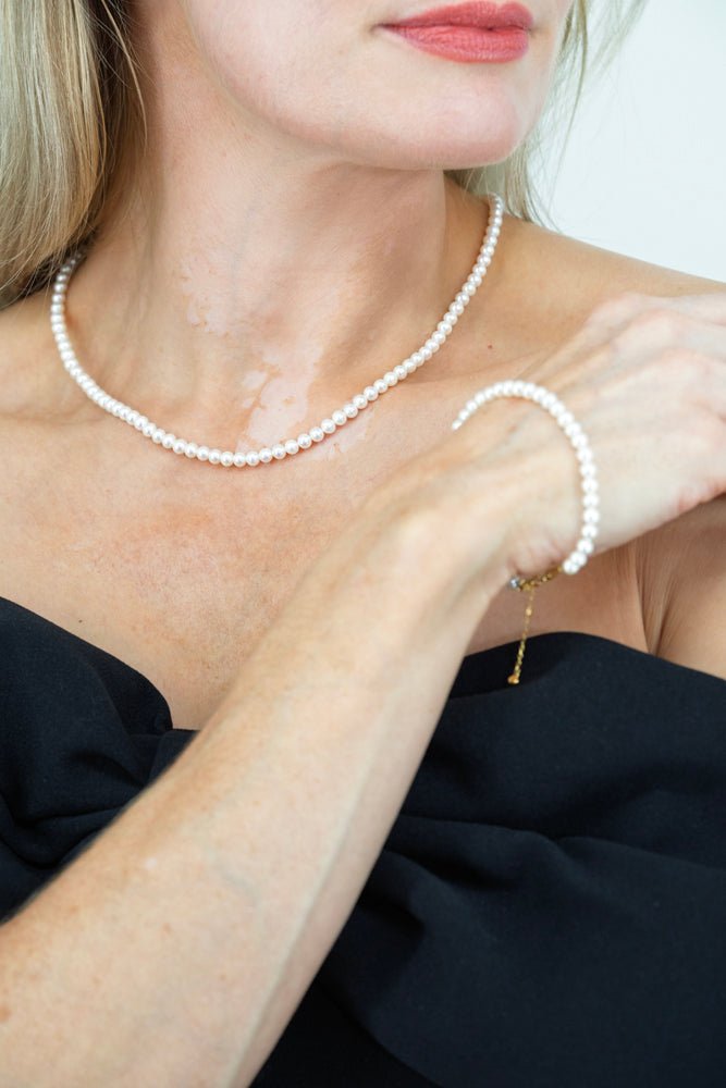 Close-up of Royale Pearlisma AAA freshwater pearl necklace and earrings crafted in sterling silver with gold plating