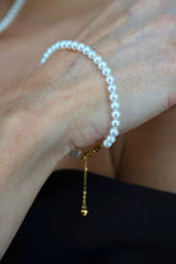 Flat lay of Royale Pearlisma Pearl Necklace with round AAA freshwater pearls and sterling silver clasp