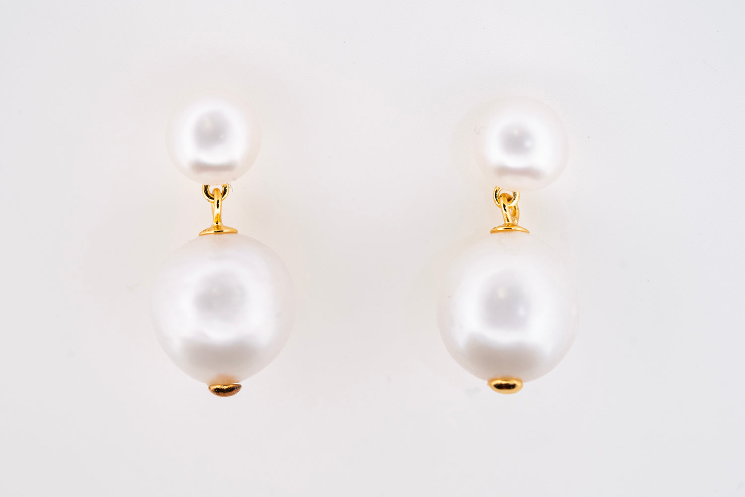 Close-up of Classic Pearl Earrings on model showcasing mixed pearl shapes and gold accents