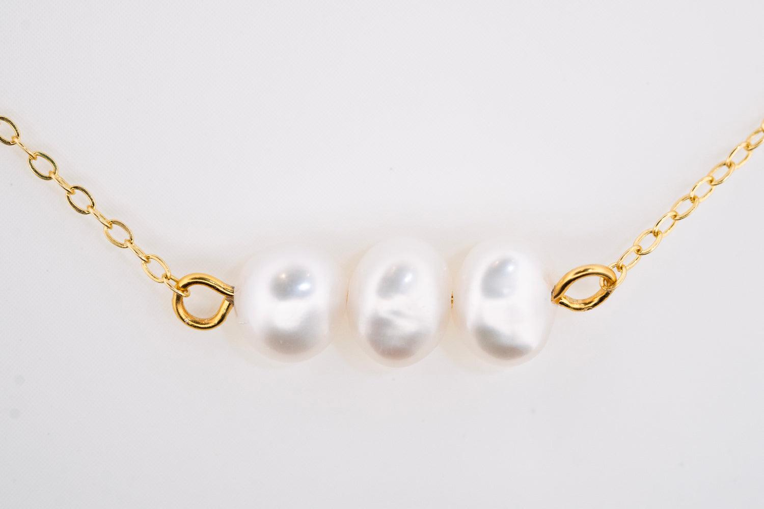 Close-up of Pearl Élan Necklace showing lustrous freshwater pearls and gold plated details