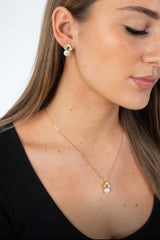 Close-up of Verona Set on model showcasing pearl and emerald jewellery in gold plated design