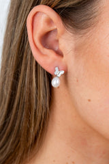 Close-up of Butterfly Pearl Whisper earrings with butterfly motif and freshwater pearl drop