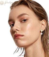 heart shaped gold pearl drop earrings on white background