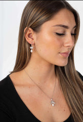 Woman wearing Lily Serenade freshwater pearl earrings with sterling silver floral design