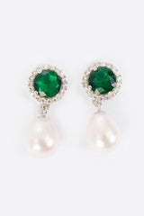 Close-up of green jewel and freshwater pearl drop earrings in sterling silver
