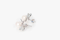 Elegant floral pearl earrings featuring white freshwater pearls and silver petals