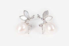 Close-up of Moonlit Fairytale Pearl stud earrings with shimmering silver details