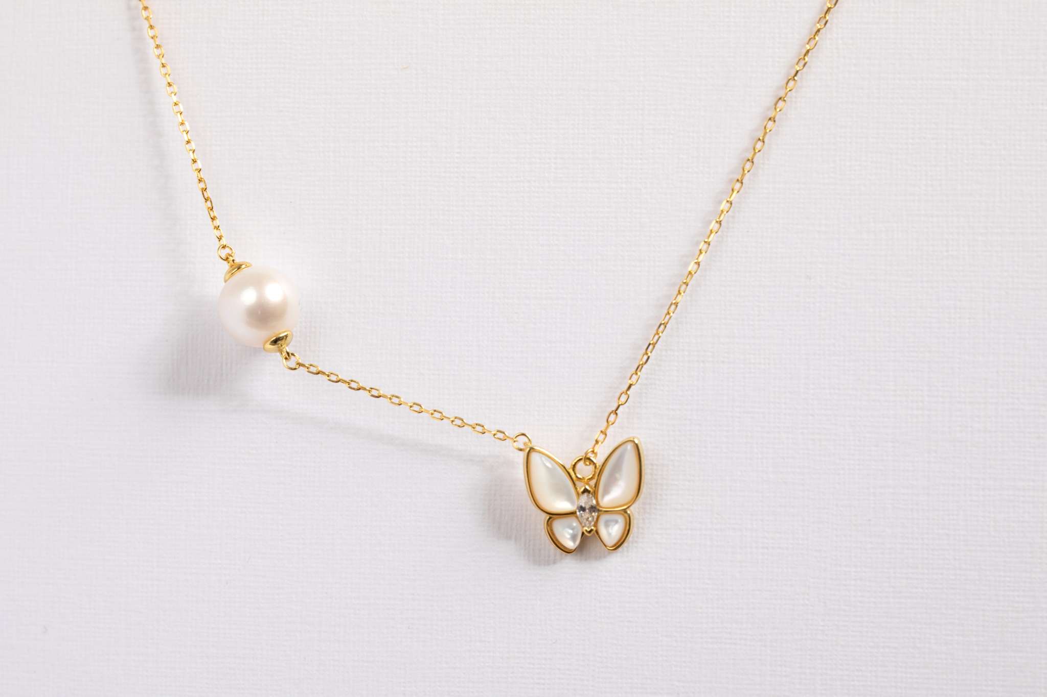 Butterfly Pearl Whisper earrings featuring gold butterfly design with freshwater pearl drops