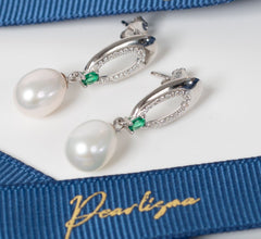 Elegant Enigma Pearl Drop Earrings set with freshwater pearls and green emerald stones