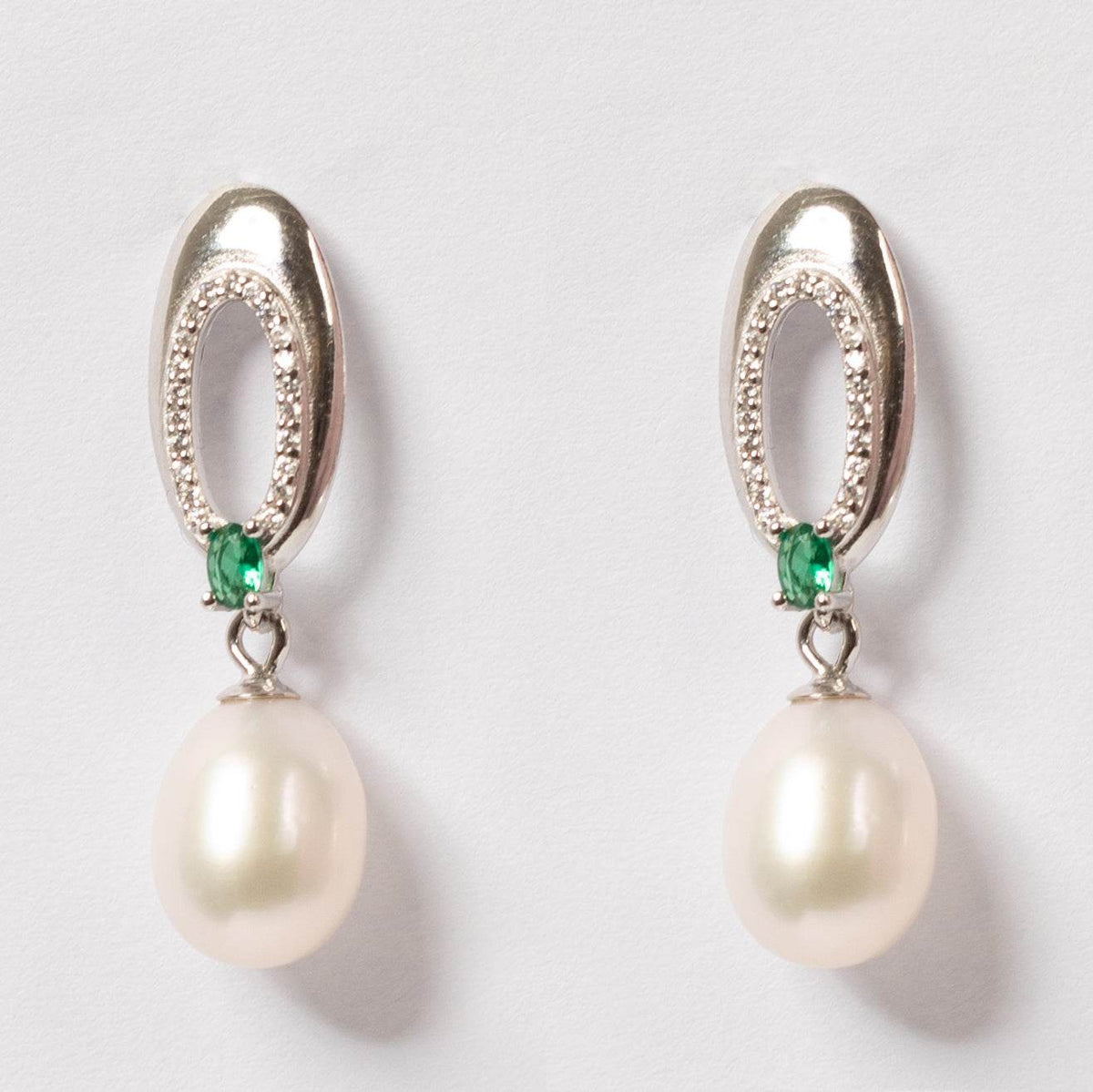 Enigma Pearl Drop Earrings featuring 7-8mm freshwater pearls with emerald accents