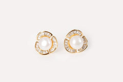 Model showcasing the minimalist rosette-inspired design of the pearl stud earrings