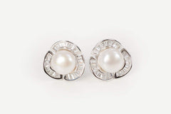 Detailed shot of rosette-style pearl studs with sterling silver setting