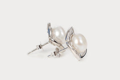 Close-up view of Rosette Pearl Studs, showing delicate rosette frame around pearl