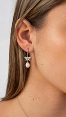 elegant silver lily flower pearl drop earrings on white background