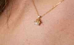 women wearing bee pearl garden necklace