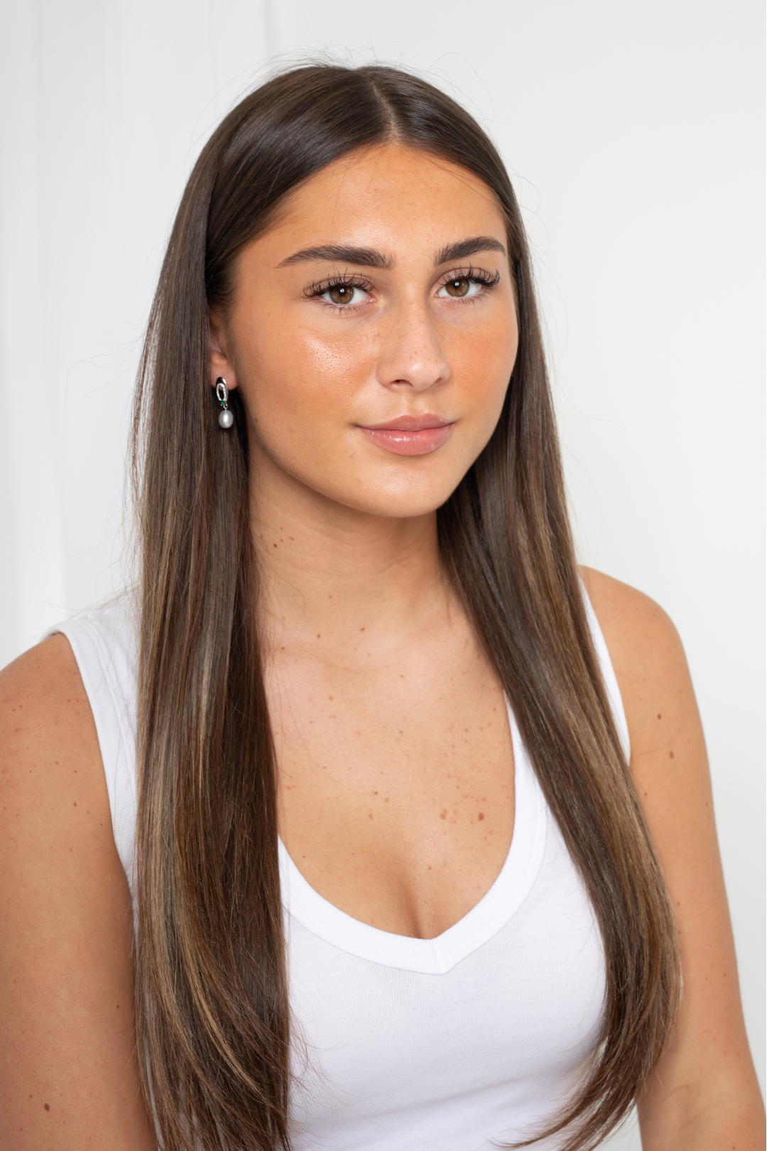 Close-up of sterling silver Enigma Pearl Drop Earrings showcasing pearl luster