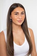 Close-up of sterling silver Enigma Pearl Drop Earrings showcasing pearl luster