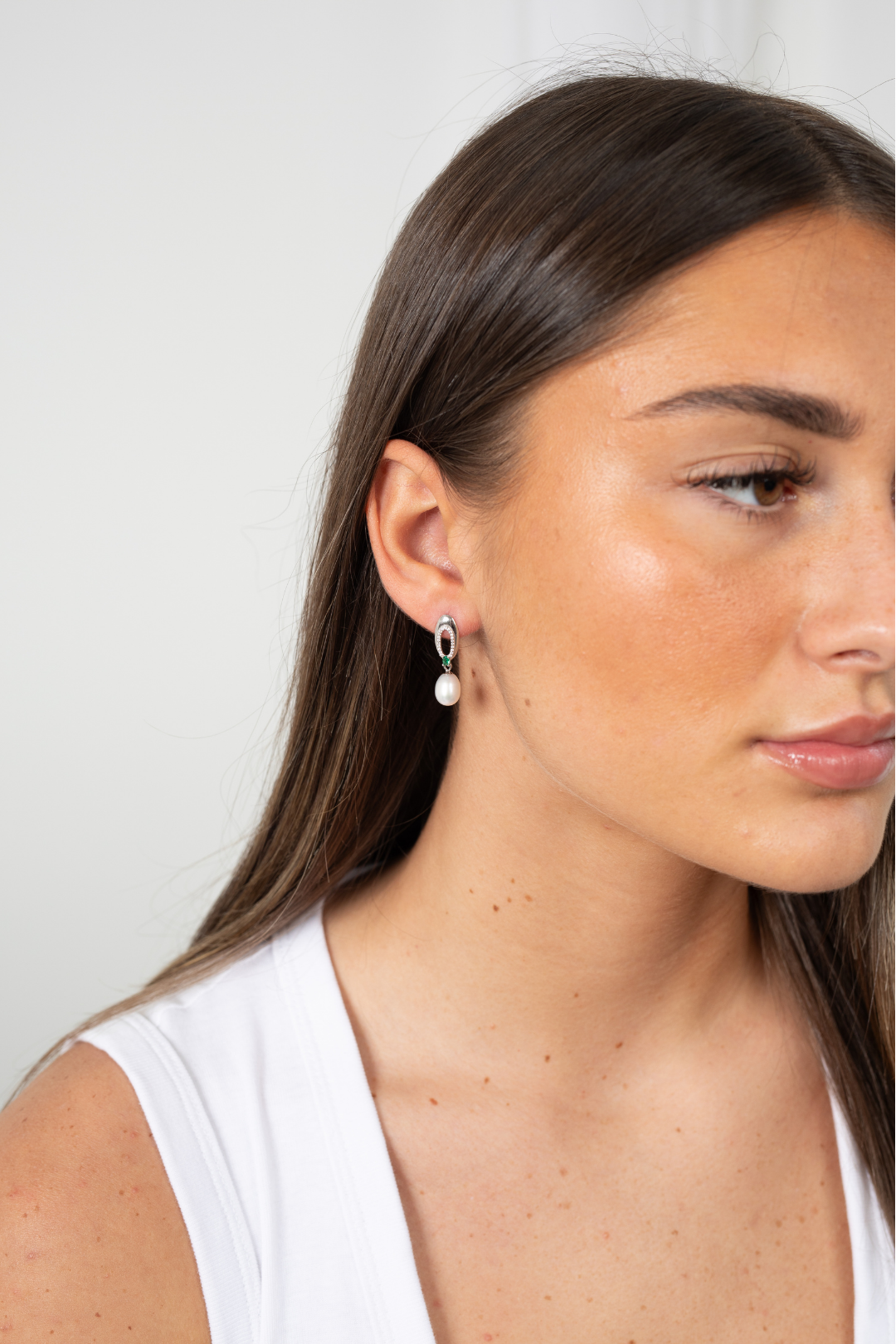 Close-up of sterling silver Enigma Pearl Drop Earrings showcasing pearl luster