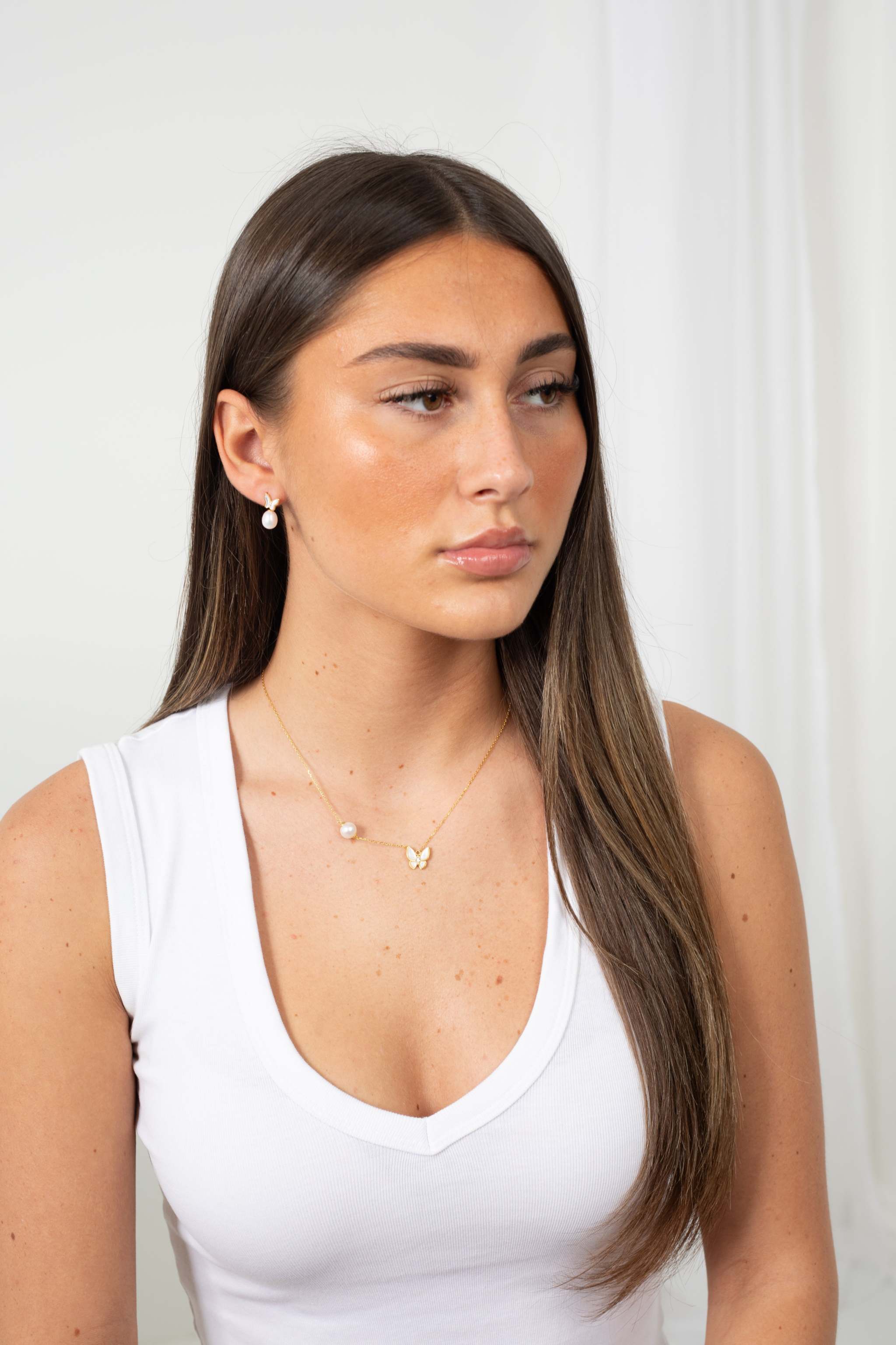 Butterfly Pearl Whisper earrings featuring gold butterfly design with freshwater pearl drops